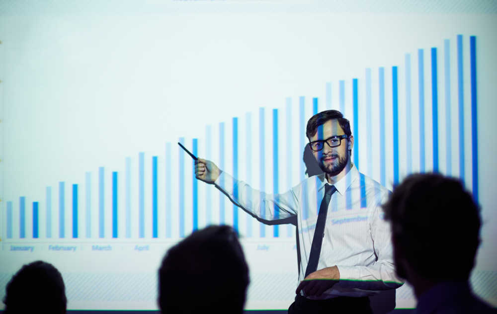 Businessman presenting report of progress on the wall