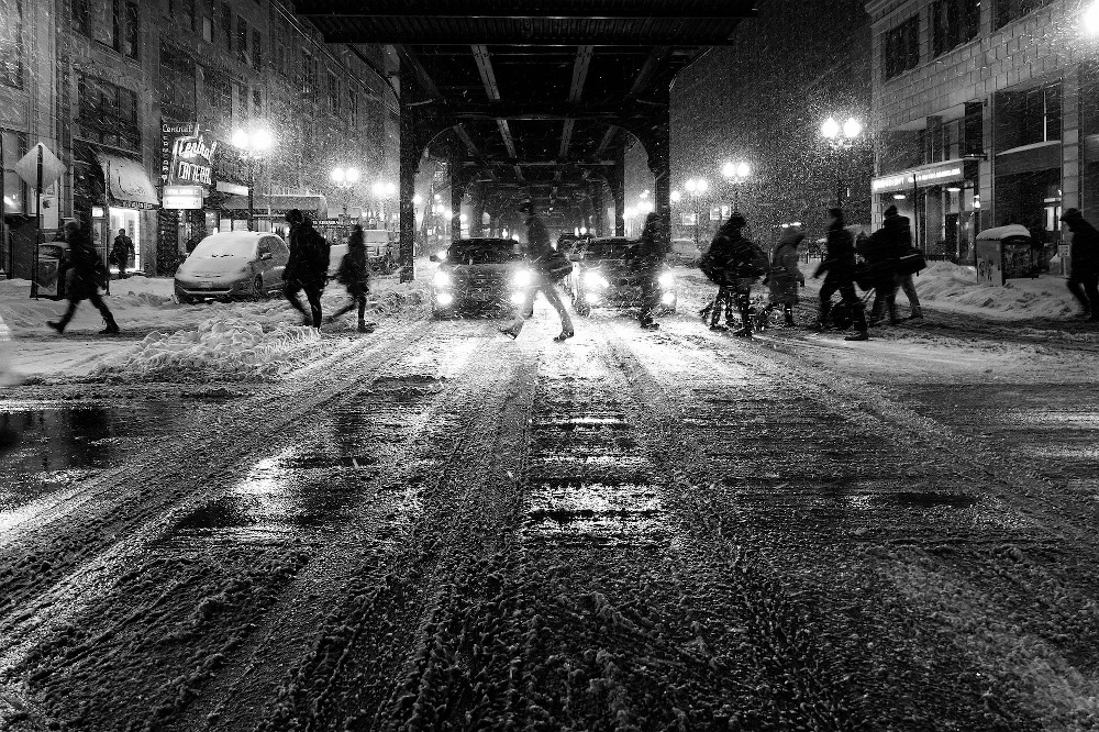 People walking in the snow in city streets
